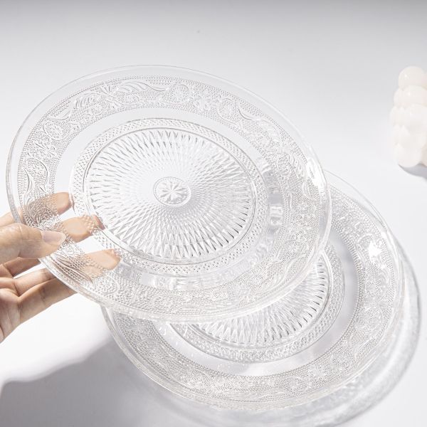 Elegant glass side plates featuring intricate embossed patterns, ideal for showcasing a vibrant assortment of fruits and snacks, enhancing the dining experience
