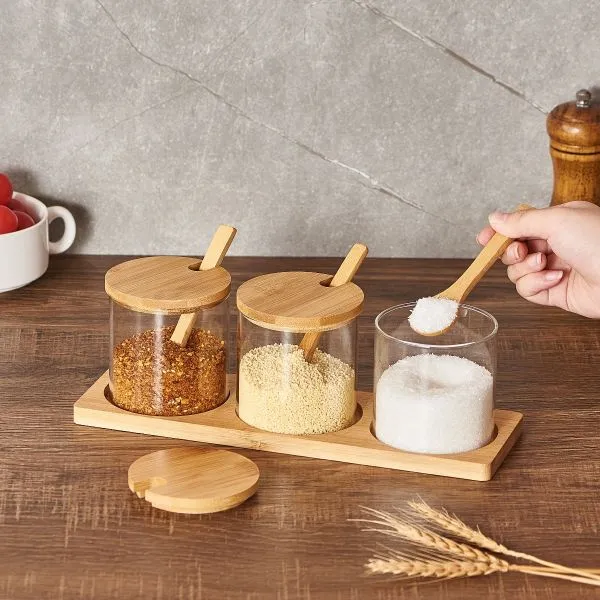 Round Glass jar set with bamboo lids and spoons on a wooden tray